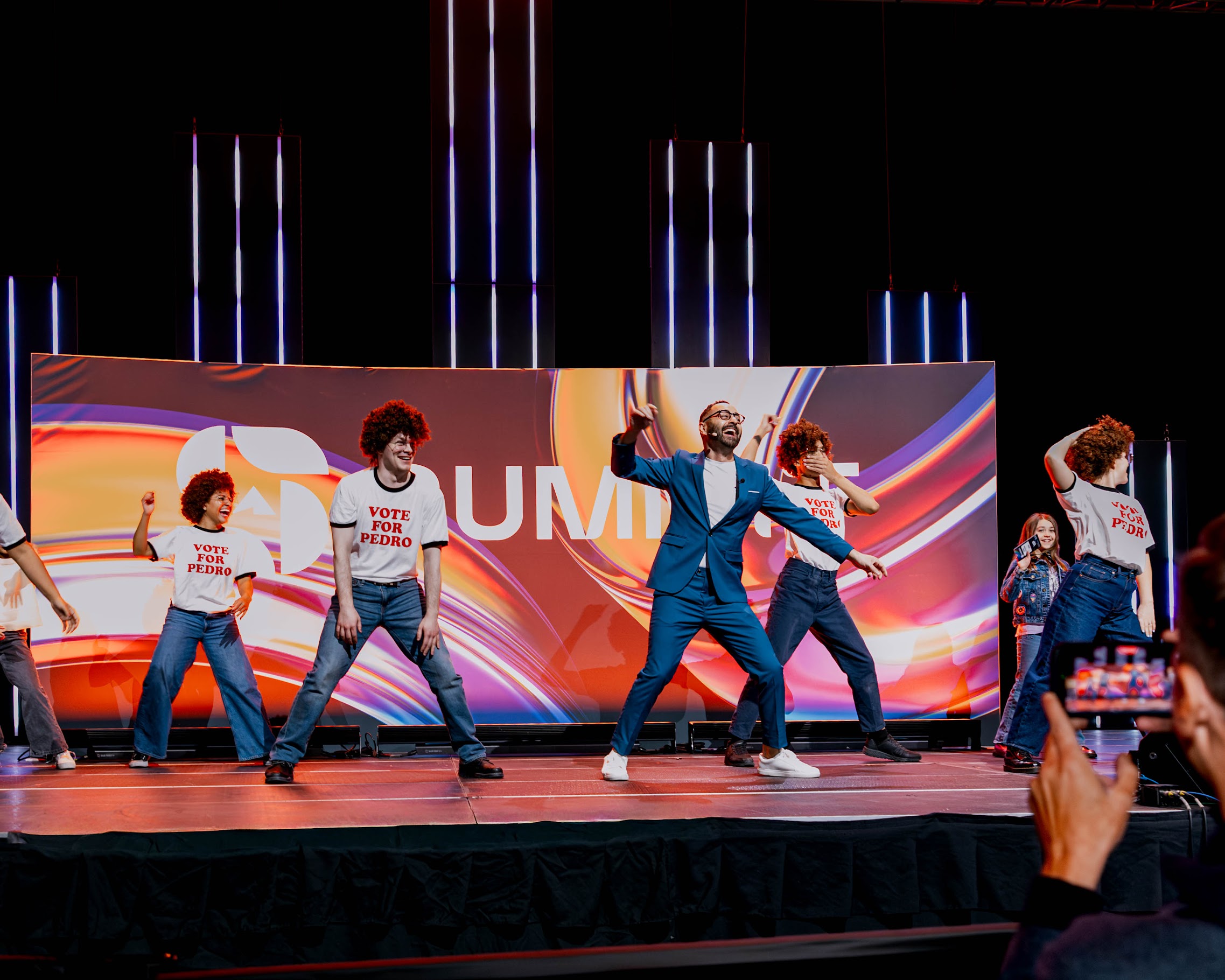 Bahaa dancing onstage with a group of performers